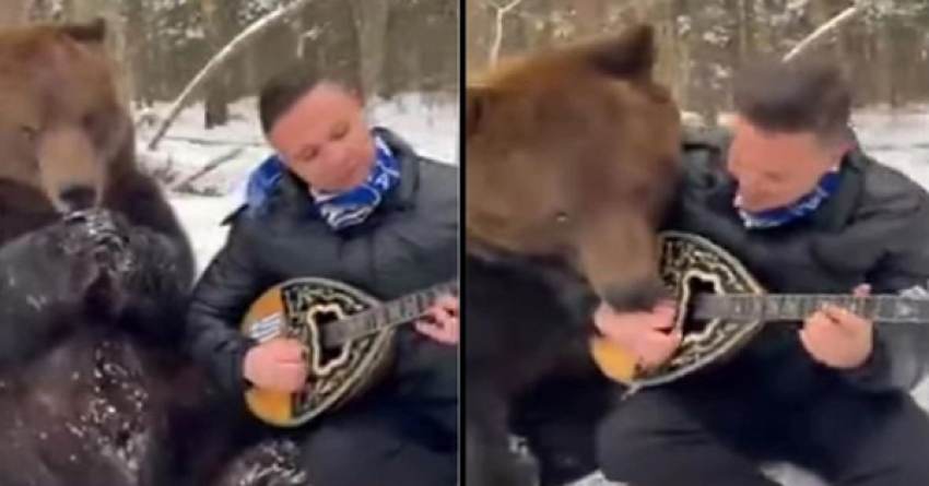 Έγινε viral παίζοντας μπουζούκι στα χιόνι με μια αρκούδα δίπλα του να τον γλείφει (vid)
